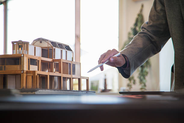 3D architectural model Close up of a 3D architectural model as a designer or architect points at it with a stylus. Kyoto, Japan. May 2016 architectural model house stock pictures, royalty-free photos & images