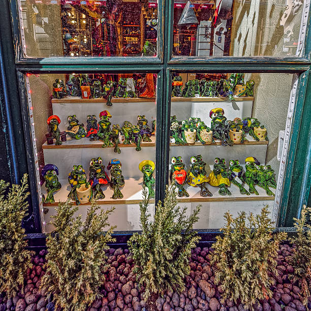 Riga, Latvia - April 30, 2016: Window of souvenir shop with set of frog figurines in Riga, Lavia.