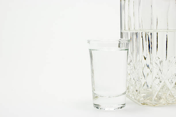 istock Carafe and glass of vodka on white 539449714