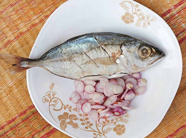 istock Fresh mackerels with onion in dish for cooking 539451608