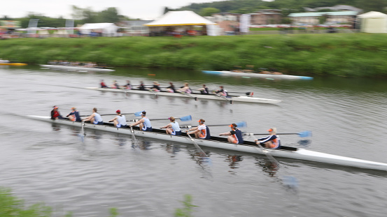 Durham, England - June 12, 2016: Two teams of eight rowers racing on the River Wear during the 183rd Durham Regatta. The regatta is the second oldest in England and attracts in excess of two thousand competitors including international entries,  with up to ten thousand spectators from across the United Kingdom.