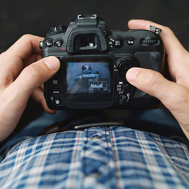 istock Photographer reiewing photos on his camera 539452662