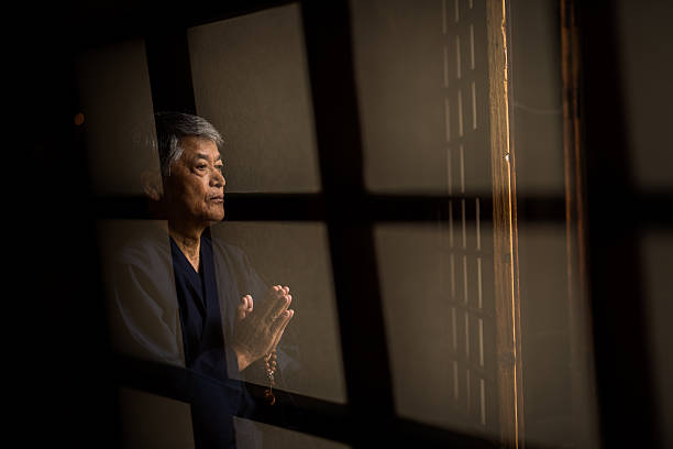 istock Senior Japanese man praying at a temple 539452930
