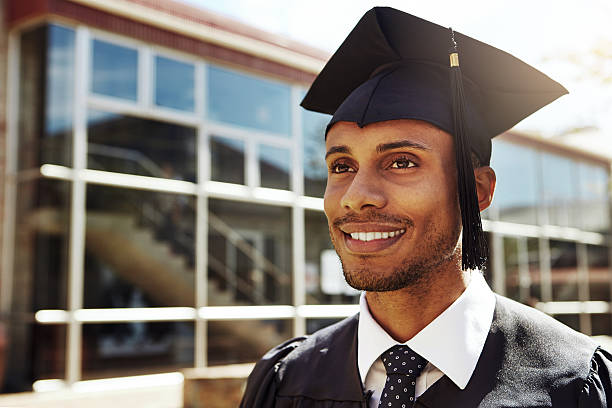 I have a bright future ahead of me Shot of a smiling university student outside on graduation day graduation man stock pictures, royalty-free photos & images