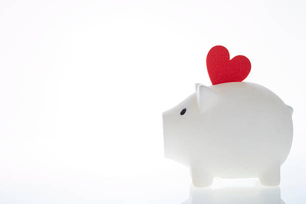 istock Piggy bank with heart shaped object 539456028