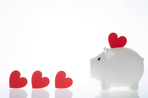 istock Piggy bank with heart shaped object 539456054