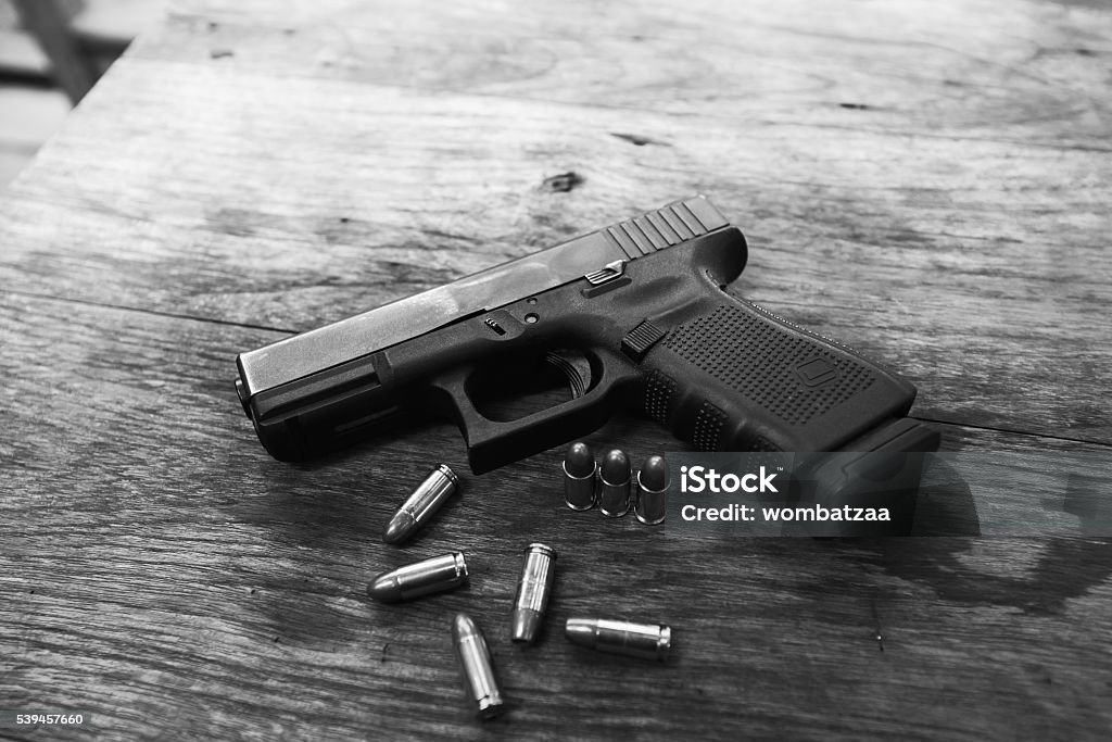 handgun bullets on wood table Gun Stock Photo