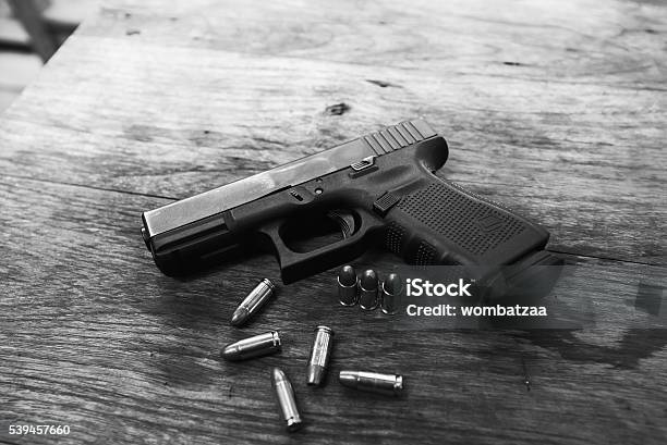 Handgun Bullets On Wood Table Stock Photo - Download Image Now - Gun, Weapon, Ammunition