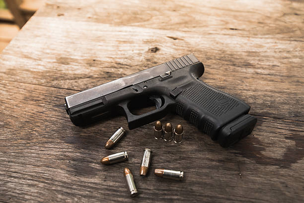 istock handgun bullets on wood table 539457874