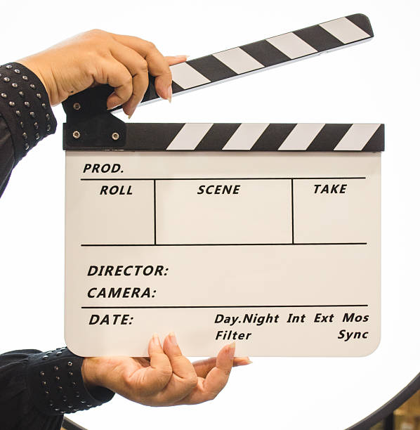 istock Movie Clapboard with hands, on spotlight background, isolated. M 539458748