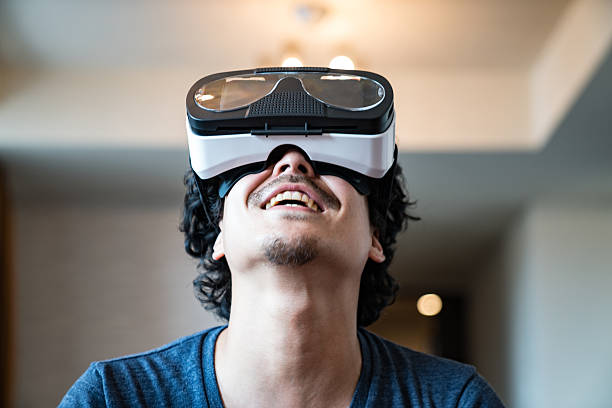 istock Young man trying out virtual reality headset for first time 539461032