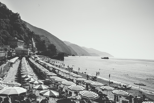 Italian Beach with colorful umbrellas on Mediterranean coastline with a vintage black and white postcard look