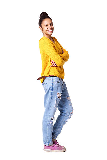 Smiling young african woman with her arms crossed Full body portrait of smiling young african woman with her arms crossed standing on white background excited woman yellow stock pictures, royalty-free photos & images