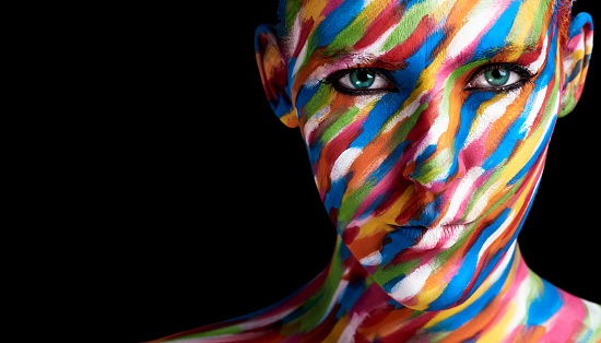 Cropped portrait of a young woman posing with paint on her face