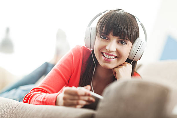 istock Woman with headphones using a tablet 539463878
