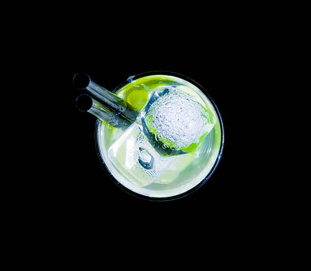 glass with cocktail and ice with lime slice