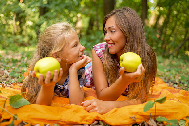 istock Mother And Daughter With Apple 539464630