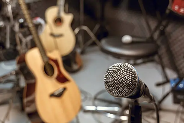 Photo of selective focus microphone and blur musical equipment.