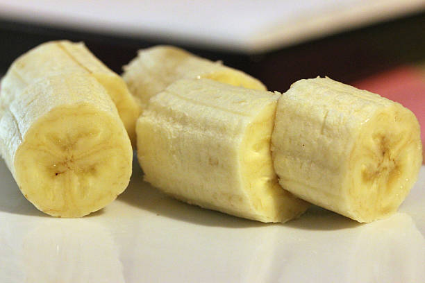 istock Several banana slices on a flat white plate 539465388