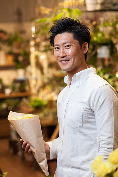 istock Man holding a rose in a flower shop 539466228