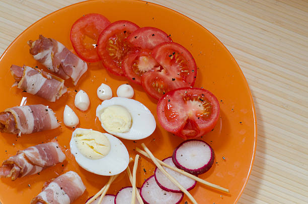 istock bacon with egg, radish and tomato on a plate 539468044