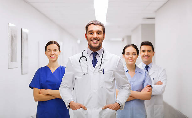 happy group of medics or doctors at hospital stock photo