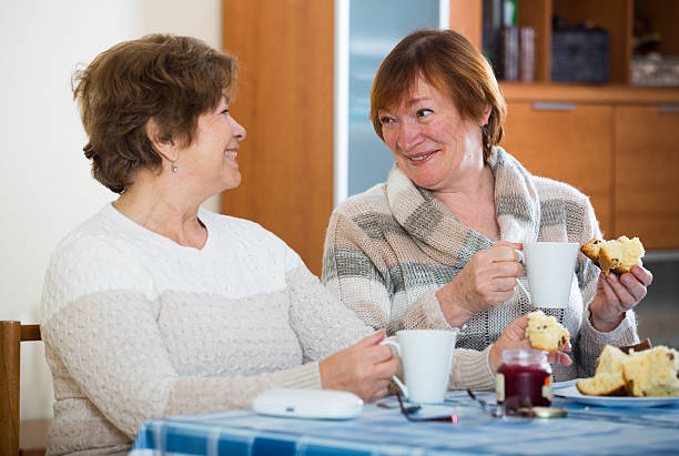 istock Positive female pensioners drinking coffee and chatting 539469976