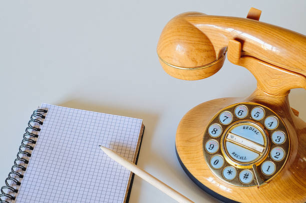 istock Isolated landline phone, notebook and pencil 539471510