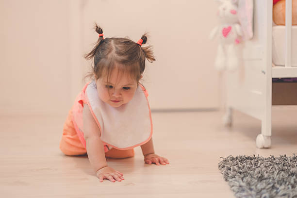 istock baby crawling in nursery on a wooden floor 539472278