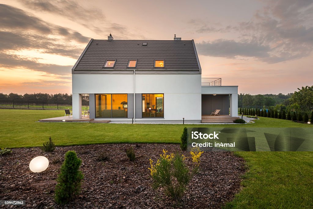 When modern architecture meets nature... Photo of elegant white villa with backyard House Stock Photo