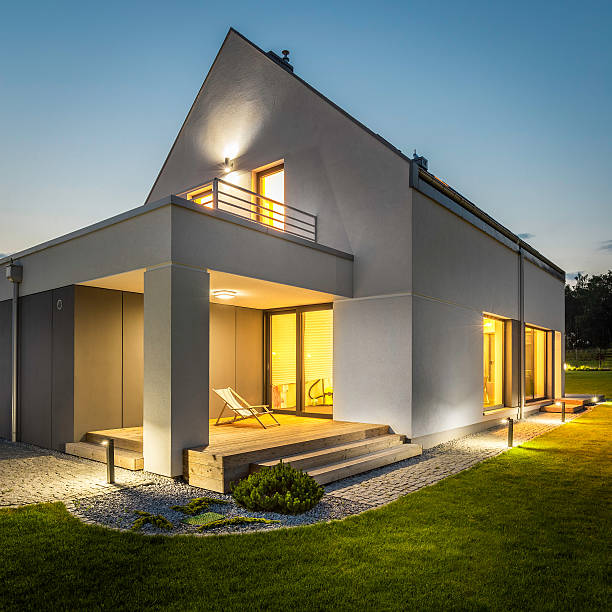 istock Exterior of illuminated house among green 539473994