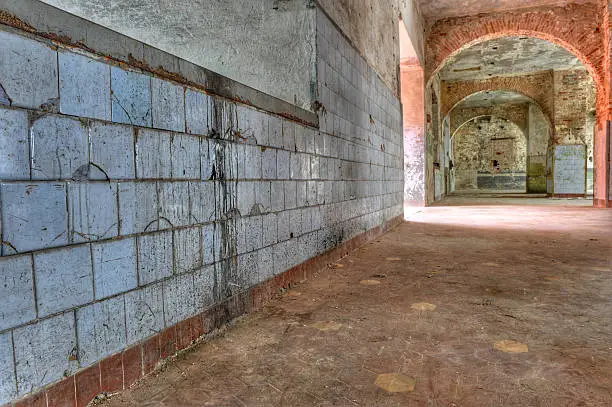 Photo of Dirty, tiled wall in an abandoned prison.