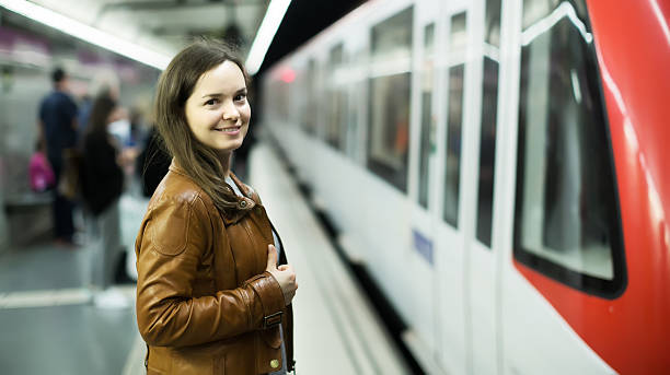 istock Cheerful female passanger standing at arrival platform 539474478
