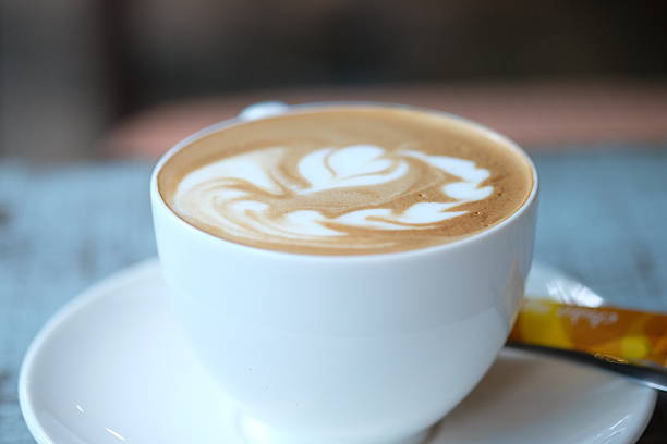 istock Cup of cappuccino on the wooden table. Close up. 539476708