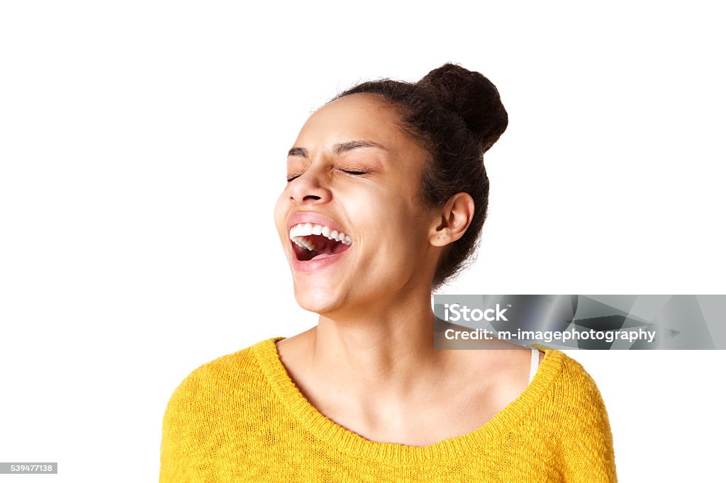 Excited young african woman laughing Close up portrait of excited young african woman laughing against white background Mouth Open Stock Photo