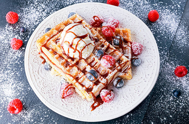 istock Belgian waffles with ice cream, chocolate sauce and fresh berries. 539478112
