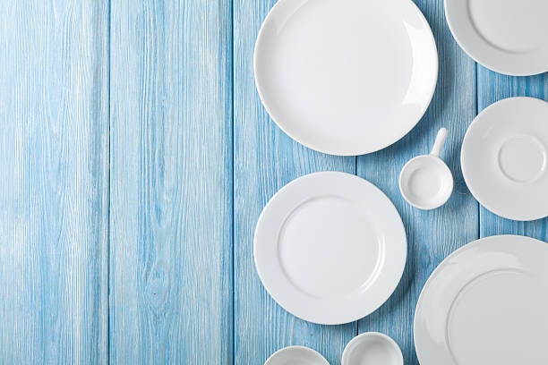 istock Empty plates and bowls on blue wooden background 539478600