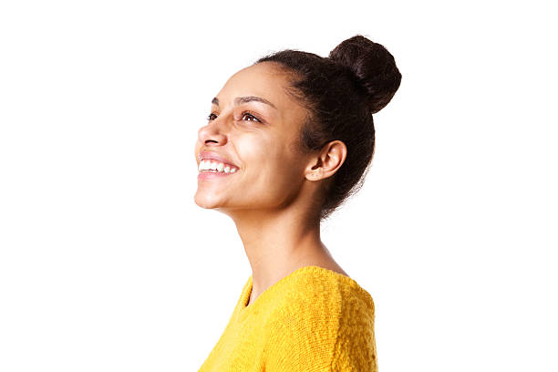 Beautiful african lady looking away and smiling Close up portrait of beautiful african lady looking away and smiling on white background side view stock pictures, royalty-free photos & images