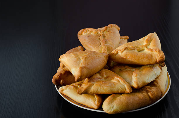 istock Plate with fresh pies on a black wooden table 539478642