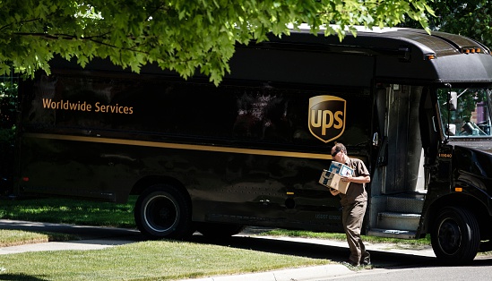 Rochester, Michigan, USA - June 08, 2016: A UPS driver making a delivery to a residence in Rochester.