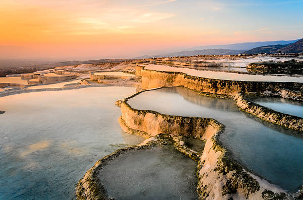 Carbonate travertines the natural pools during sunset, Pamukkale Carbonate travertines the natural pools during sunset, Pamukkale, Turkey travertine pool photos stock pictures, royalty-free photos & images