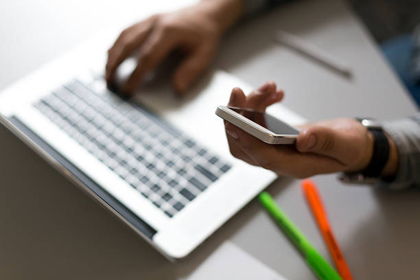 istock Man holding Telephone in front of Laptop 539480190