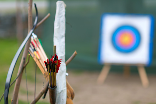 archer with bow and arrow aiming to target