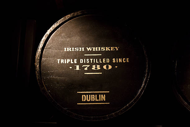 Irish Whiskey Old wooden barrel full of Dublin's Irish whiskey. whisky cellar stock pictures, royalty-free photos & images