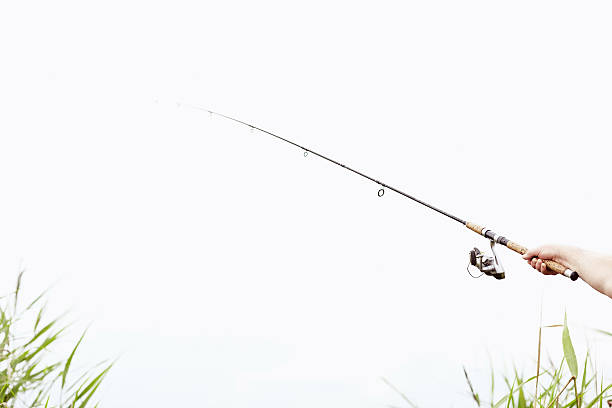 istock Fisherman with rod closeup 539481726