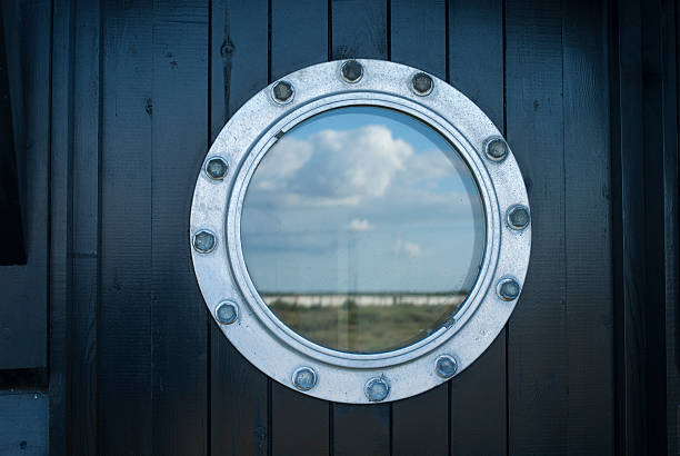 ship porthole on wooden wall