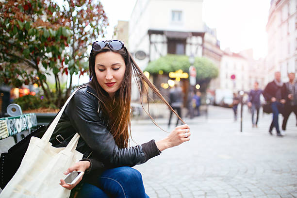istock Young Parisian woman relaxing on the bench 539484066