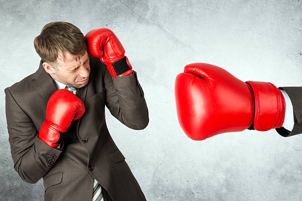 istock Businessman against red boxing glove 539484484