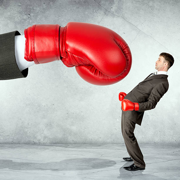 istock Businessman against red boxing glove 539640354
