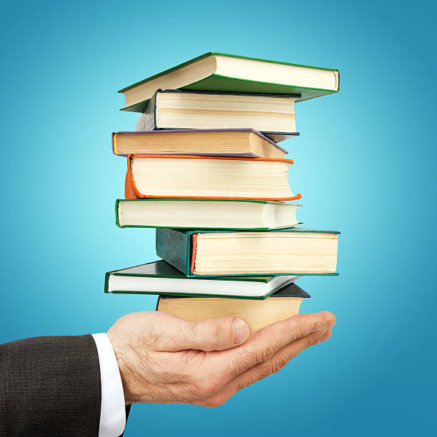 istock Business man holding stack of books 539642108